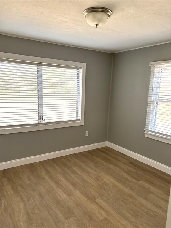 316 Brooks Road Frostproof, FL 33843 - Photo 6 of 11 an empty room with wooden floor and windows