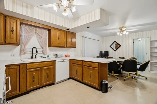 a spacious kitchen with stainless steel appliances a sink and cabinets
