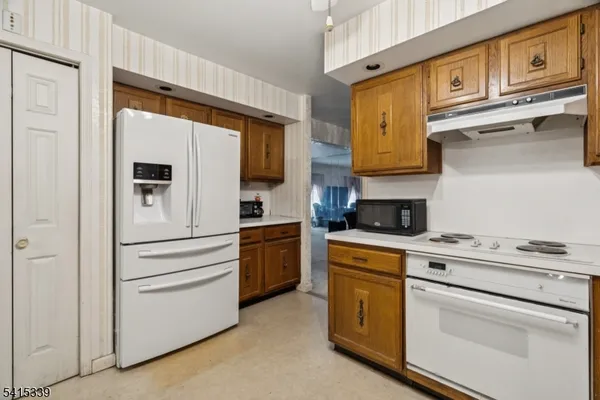 a kitchen with cabinets stainless steel appliances and counter space