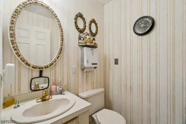a bathroom with a toilet a sink and mirror