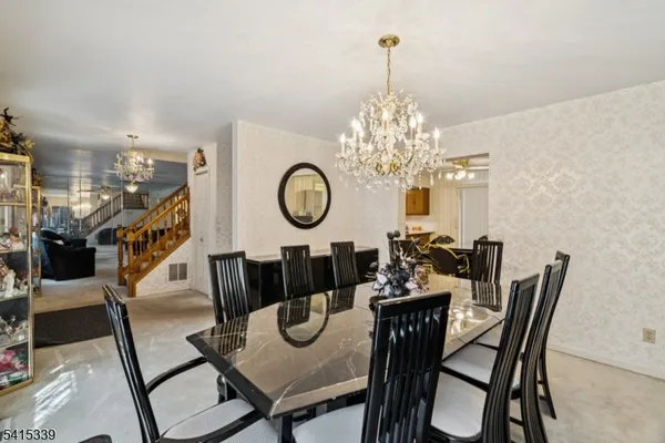 a view of a dining room with furniture and chandelier