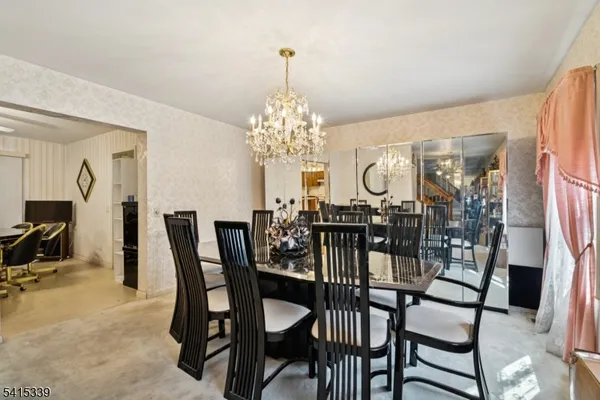 a view of a dining room with furniture and chandelier