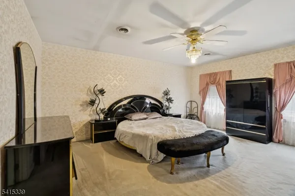 a bedroom with a bed and a chandelier