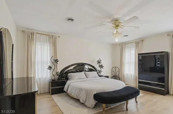a bedroom with a bed and a mirror