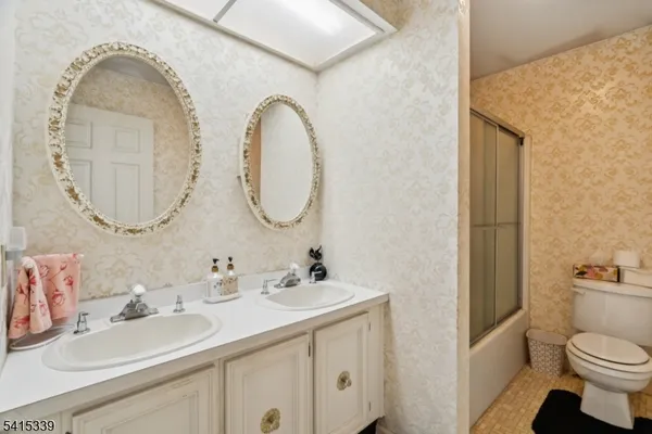a bathroom with a toilet a sink and a mirror