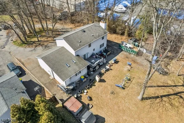 an aerial view of a house with a yard