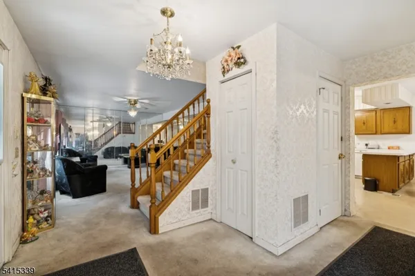 a view of entryway with furniture and stairs