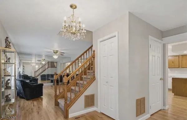 a view of entryway and hall with wooden floor