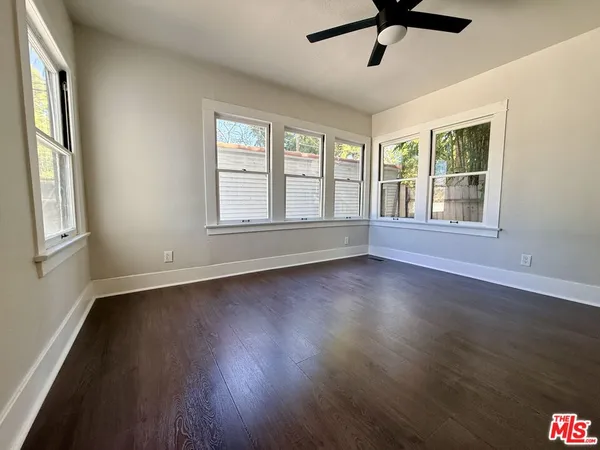 a view of wooden floor and windows in a room
