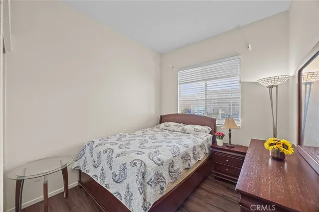 a bedroom with a bed a table and chair