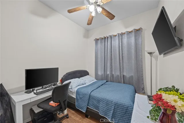 a bedroom with a bed and a flat screen tv