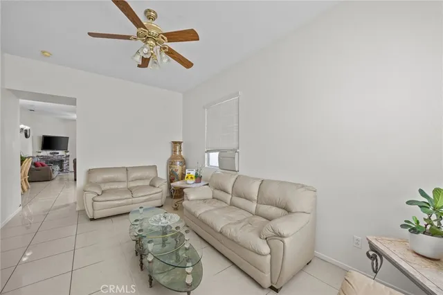 a living room with furniture and a ceiling fan