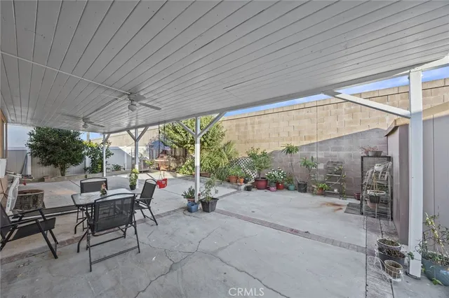 a building outdoor space with patio furniture and potted plants