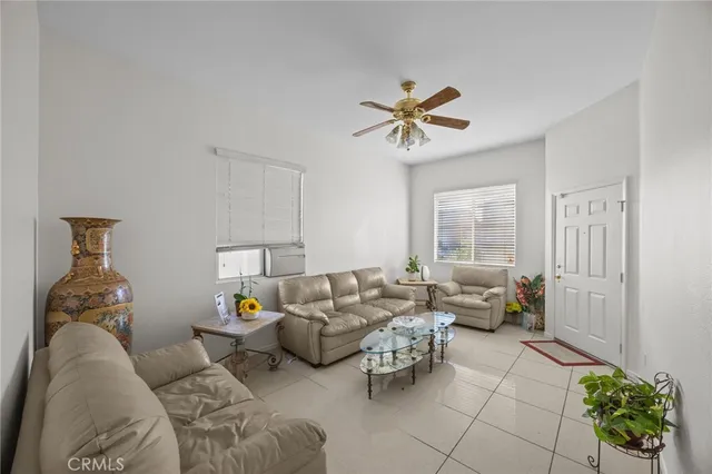 a living room with furniture flowerpot and a window