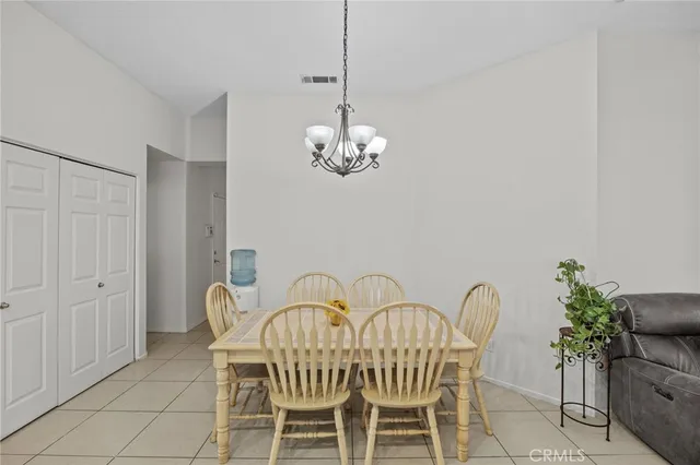a view of a dining room with furniture and chandelier