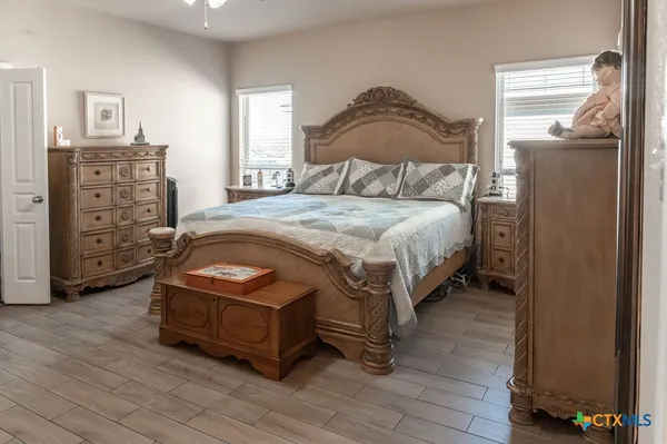 a bedroom with a bed next to a window