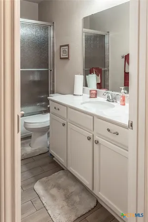 a bathroom with a sink toilet and shower