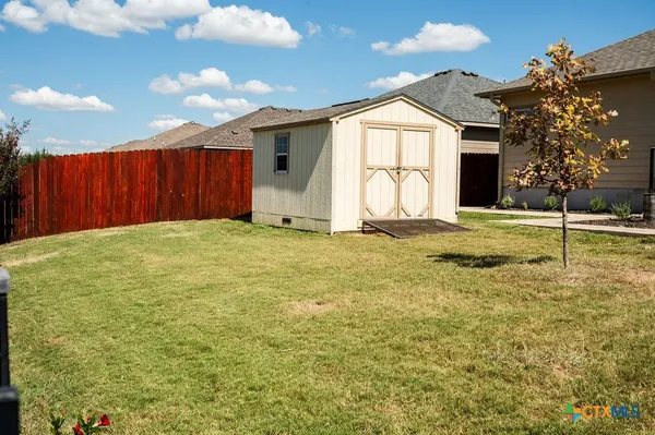 a view of a house with a yard and a garage