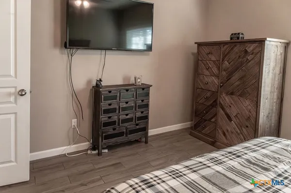 a view of a hallway with wooden floor and furniture