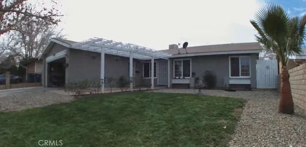 a view of a house with a yard and plants