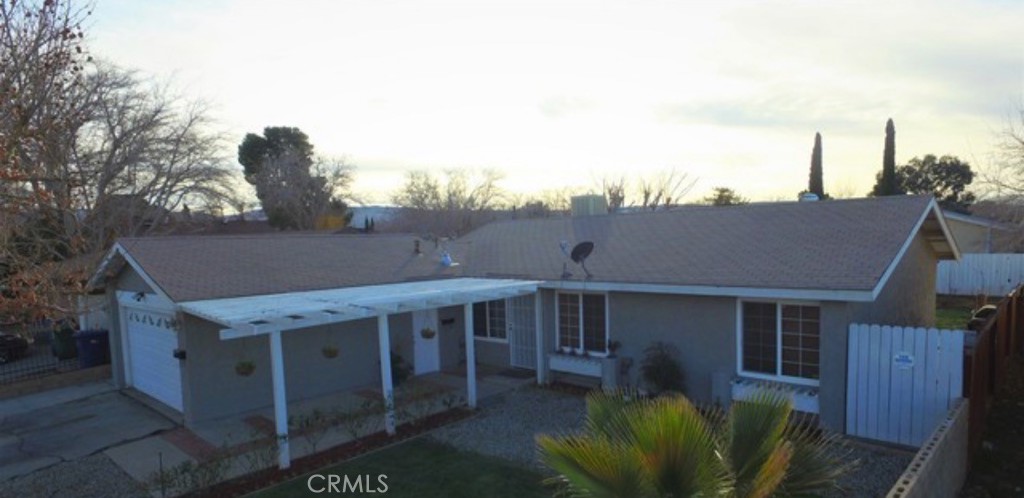 42901 Alep Street Lancaster, CA 93536 - Photo 2 of 17 a roof deck with table and chairs under an umbrella