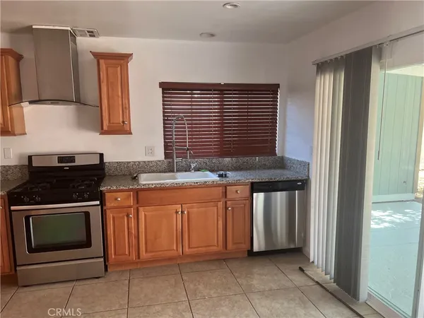 a kitchen with stainless steel appliances granite countertop a stove and a sink