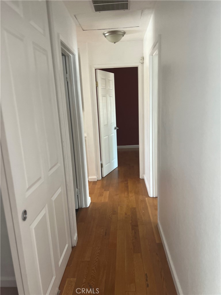 42901 Alep Street Lancaster, CA 93536 - Photo 10 of 17 a view of a hallway with wooden floor