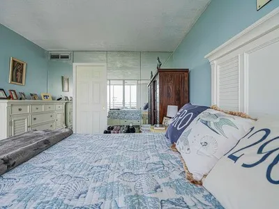 a bedroom with a bed and a couch next to a window