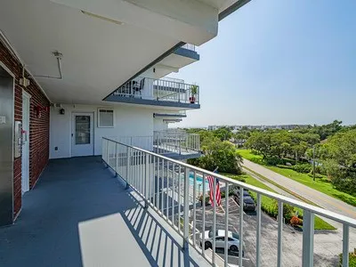 a view of balcony with wooden floor