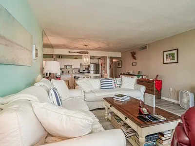 a dining room with furniture a chandelier and wooden floor