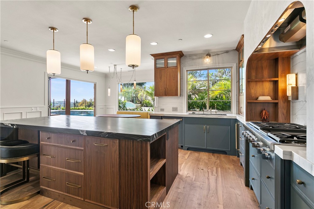 7 Kent Court Ladera Ranch, CA 92694 - Photo 11 of 49 a kitchen with stainless steel appliances granite countertop a stove a sink and a wooden floor