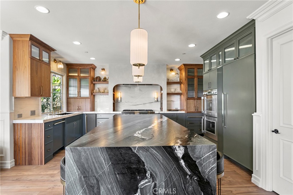 7 Kent Court Ladera Ranch, CA 92694 - Photo 13 of 49 a kitchen with stainless steel appliances granite countertop a refrigerator a sink a stove and a wooden floors