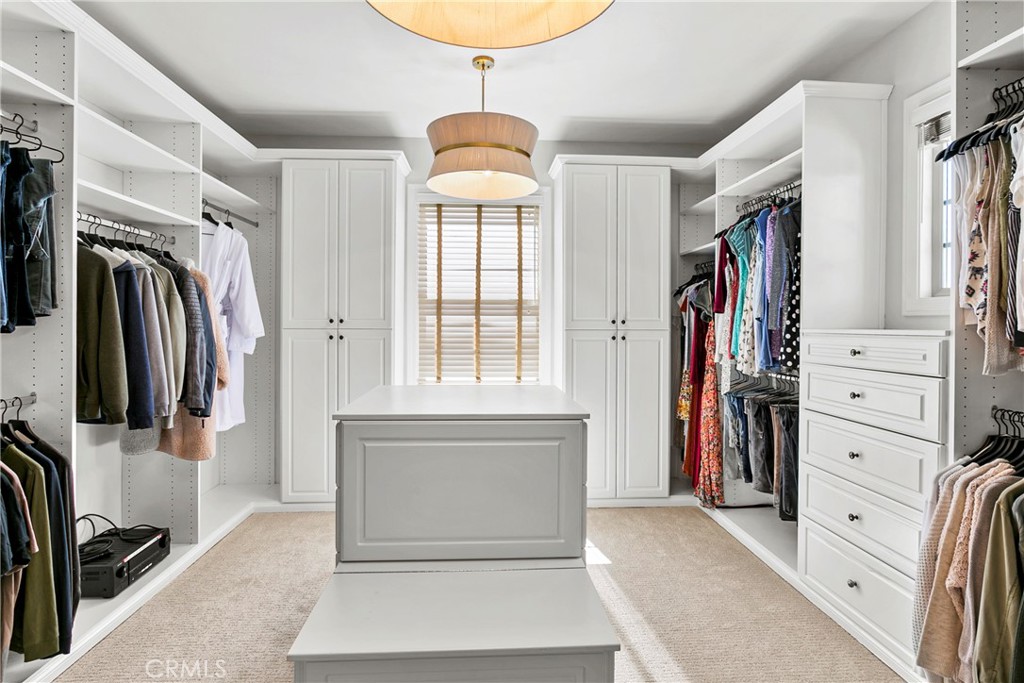 7 Kent Court Ladera Ranch, CA 92694 - Photo 37 of 49 a view of walk in closet with clothes and shoes