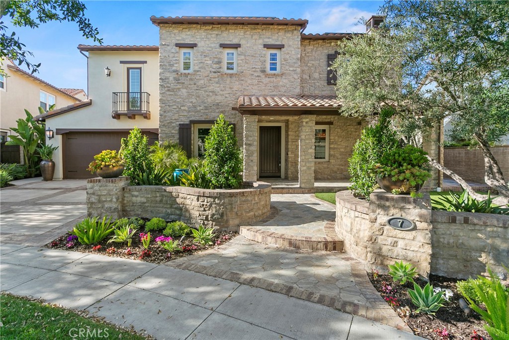 7 Kent Court Ladera Ranch, CA 92694 - Photo 5 of 49 a front view of a house with a garden