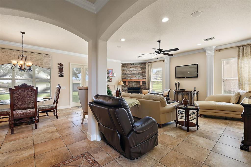 212 Crestrun Loop Leesburg, FL 34748 - Photo 11 of 47 a living room with furniture and a chandelier