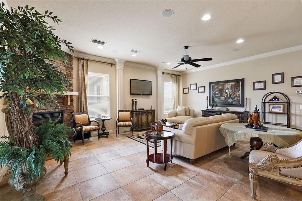 212 Crestrun Loop Leesburg, FL 34748 - Photo 14 of 47 a living room with furniture potted plant and a large window