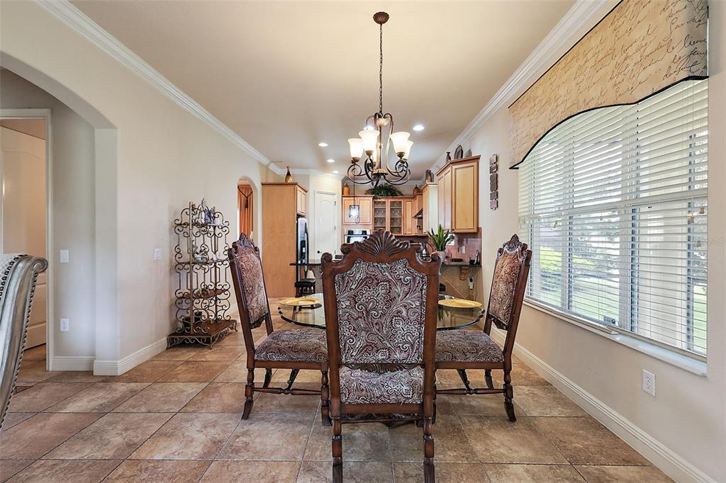 212 Crestrun Loop Leesburg, FL 34748 - Photo 15 of 47 a view of a dining room with furniture and chandelier