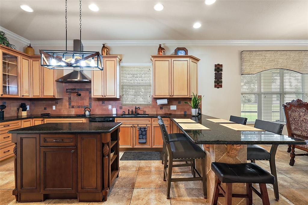 212 Crestrun Loop Leesburg, FL 34748 - Photo 19 of 47 a kitchen with a table chairs sink and cabinets