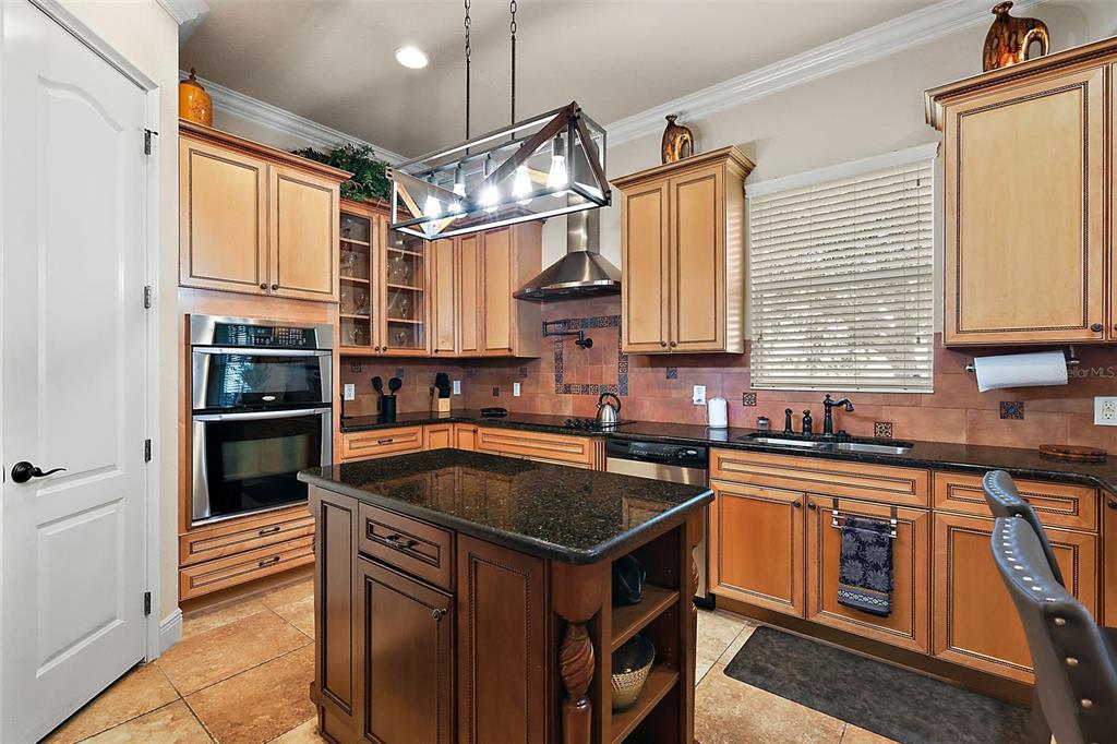 212 Crestrun Loop Leesburg, FL 34748 - Photo 20 of 47 a kitchen that has a sink and a stove in it
