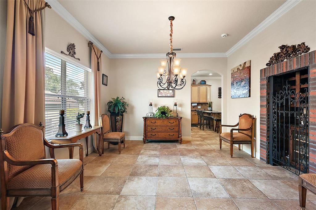 212 Crestrun Loop Leesburg, FL 34748 - Photo 24 of 47 a living room with furniture and a chandelier
