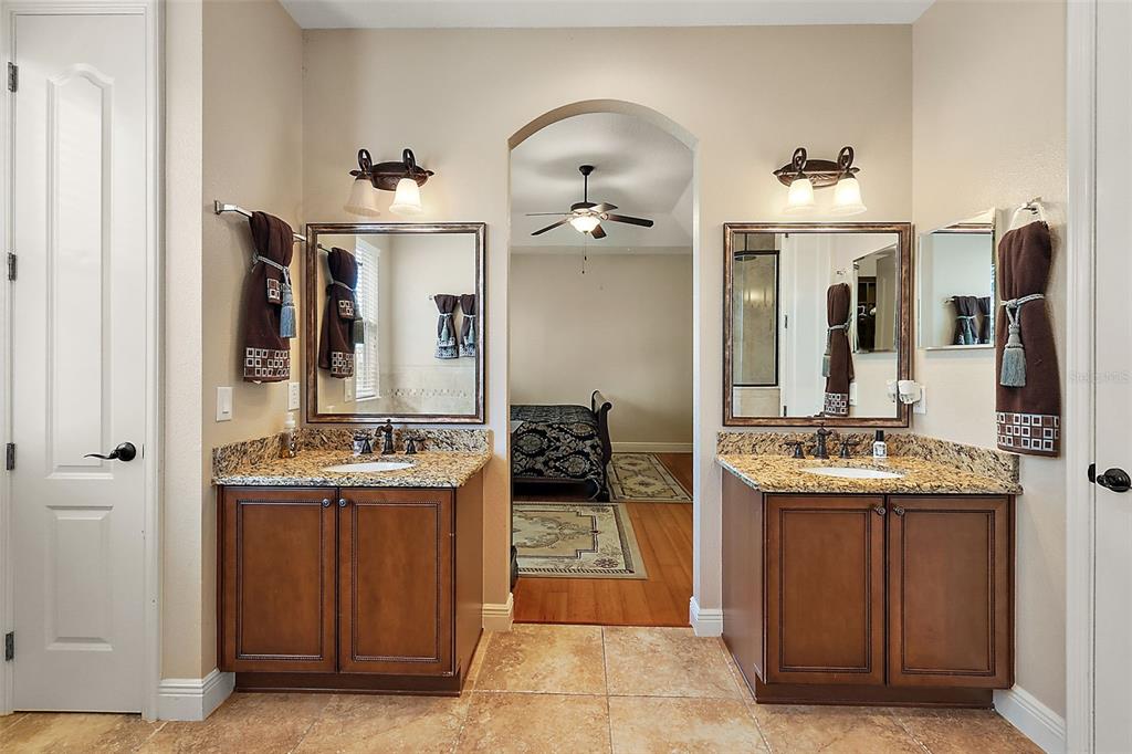 212 Crestrun Loop Leesburg, FL 34748 - Photo 31 of 47 a en suite bathroom with a sink and a mirror