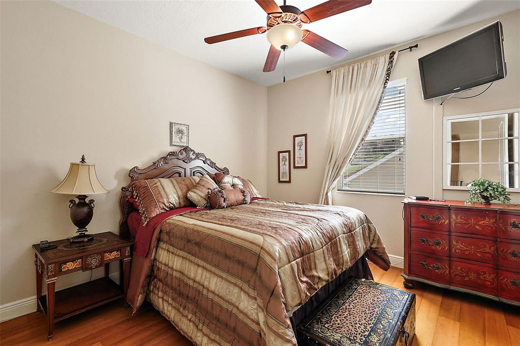 212 Crestrun Loop Leesburg, FL 34748 - Photo 32 of 47 a bedroom with a bed a flat screen tv and dresser