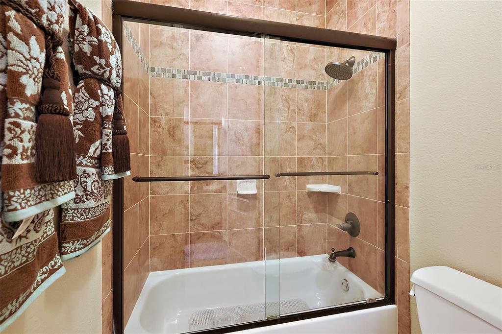 212 Crestrun Loop Leesburg, FL 34748 - Photo 33 of 47 a bathroom with a bathtub and a shower