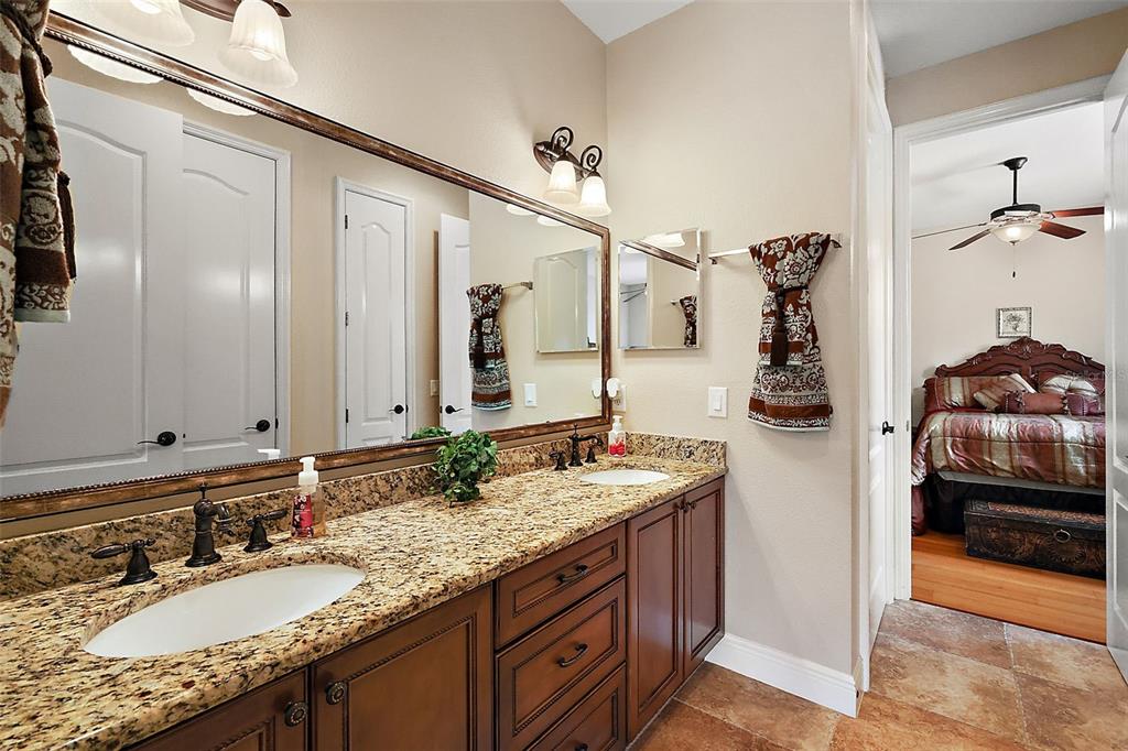 212 Crestrun Loop Leesburg, FL 34748 - Photo 34 of 47 a bathroom with a granite countertop sink and a mirror