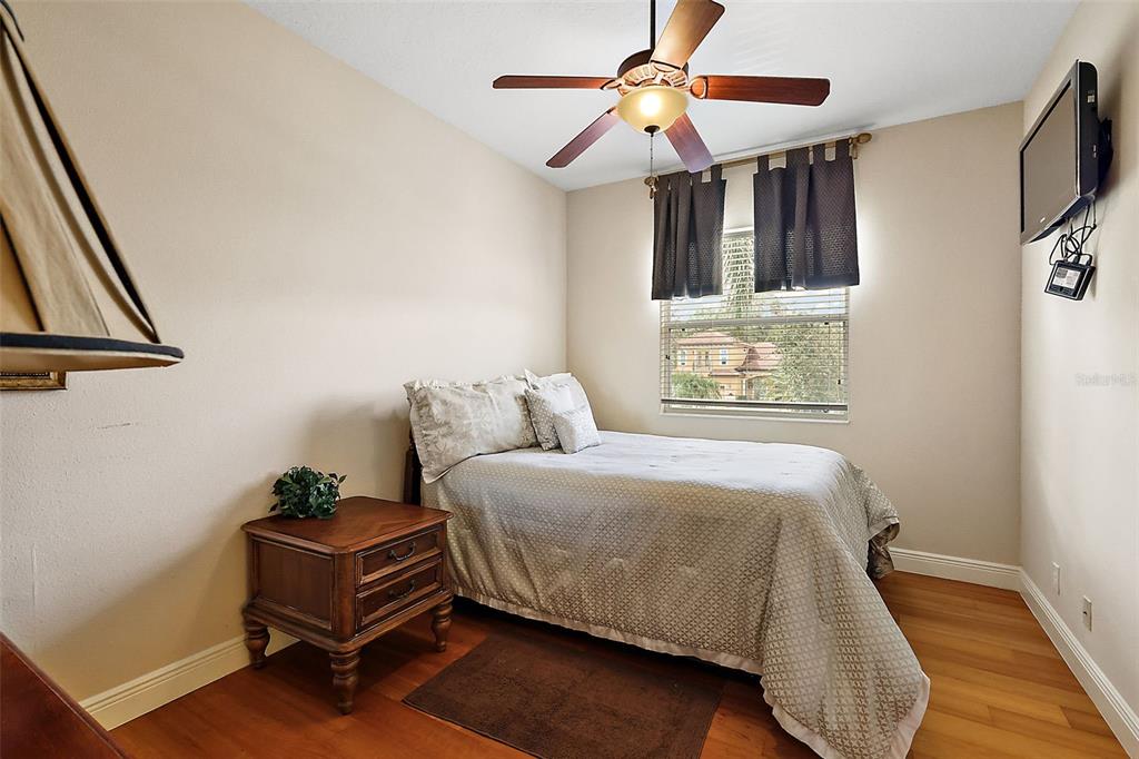 212 Crestrun Loop Leesburg, FL 34748 - Photo 35 of 47 a bedroom with a bed window and a chandelier