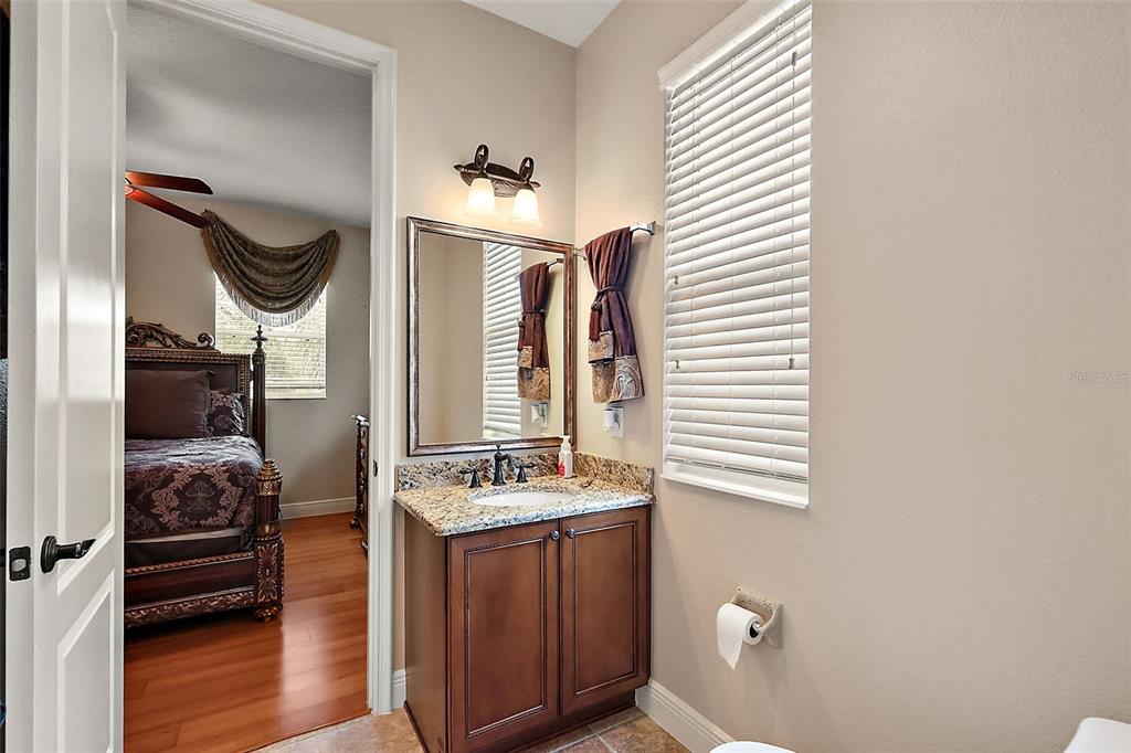 212 Crestrun Loop Leesburg, FL 34748 - Photo 37 of 47 a bathroom with a sink a mirror and a toilet