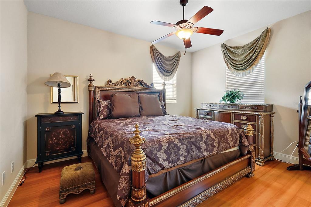 212 Crestrun Loop Leesburg, FL 34748 - Photo 39 of 47 a bedroom with a bed and a chandelier