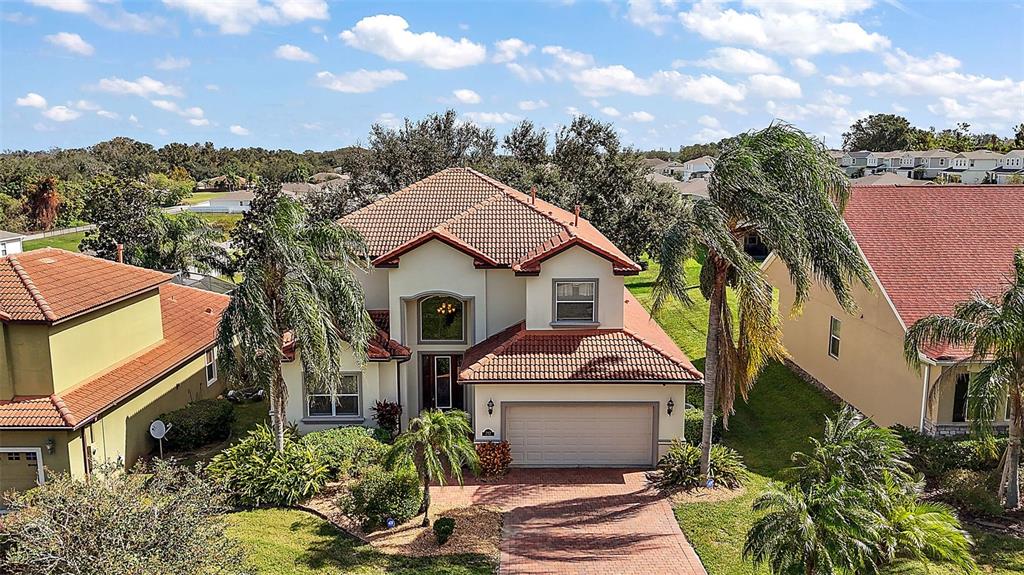 212 Crestrun Loop Leesburg, FL 34748 - Photo 46 of 47 a front view of a house with a yard and fountain