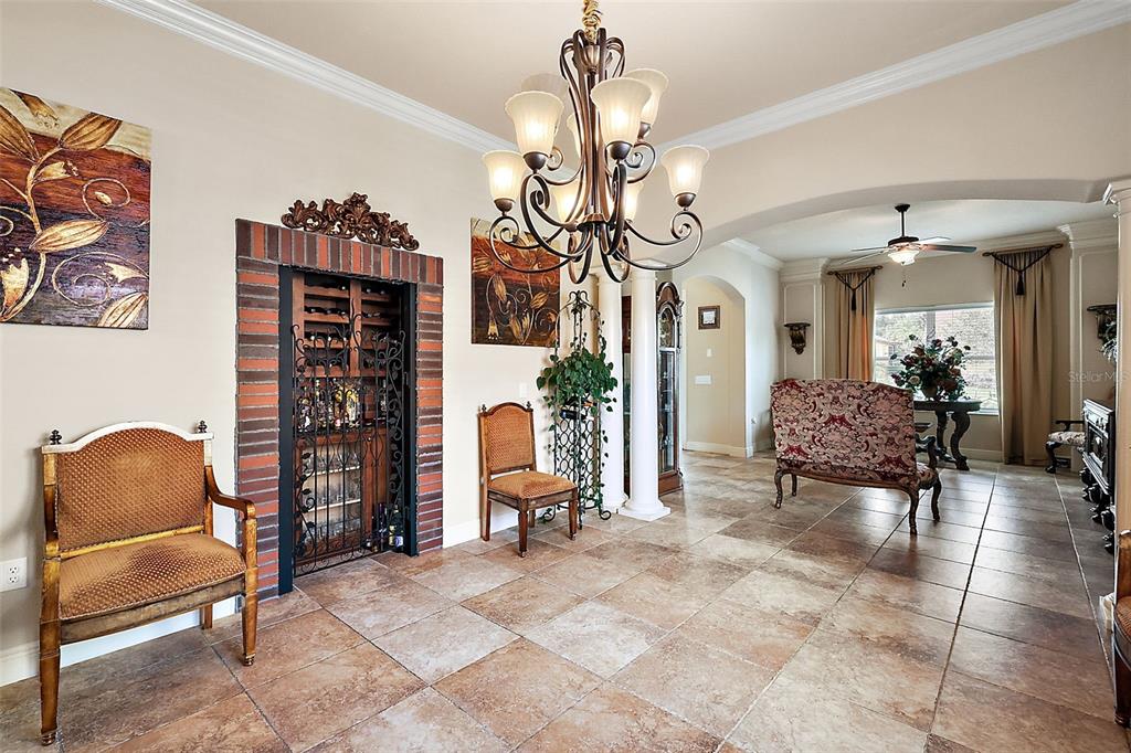 212 Crestrun Loop Leesburg, FL 34748 - Photo 6 of 47 a living room with furniture and a chandelier