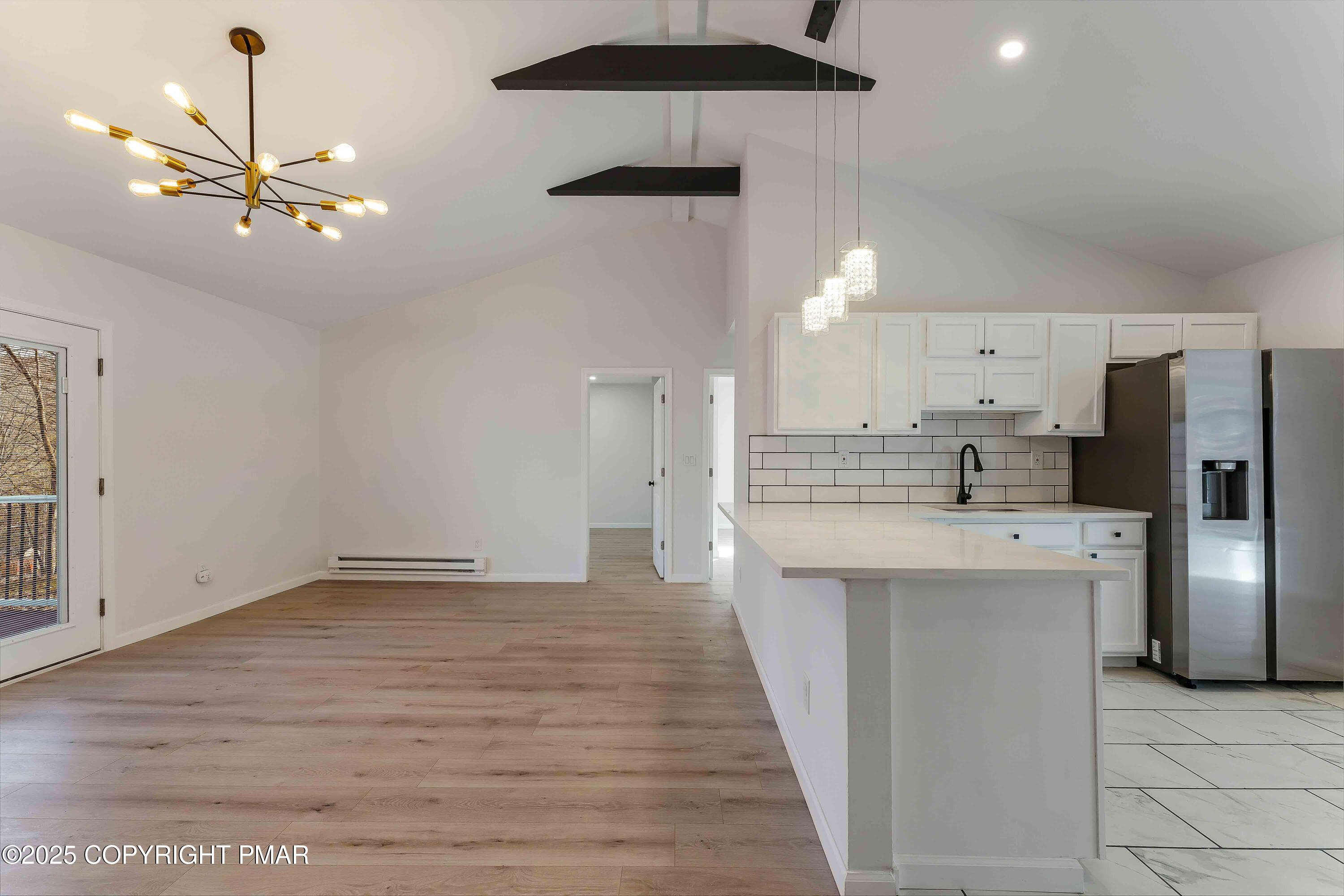 218 Vista Road Cresco, PA 18326 - Photo 17 of 54 a large kitchen with stainless steel appliances a refrigerator sink and white cabinets